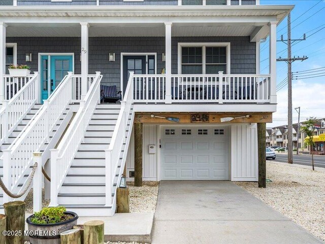 29 7th Ave Unit B, Seaside Heights, NJ 08751 - view of front of property with a garage, a porch, concrete driveway, and stairs