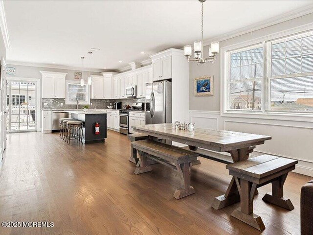 29 7th Ave Unit B, Seaside Heights, NJ 08751 - dining room with ornamental molding, a chandelier, wainscoting, and dark wood-style floors
