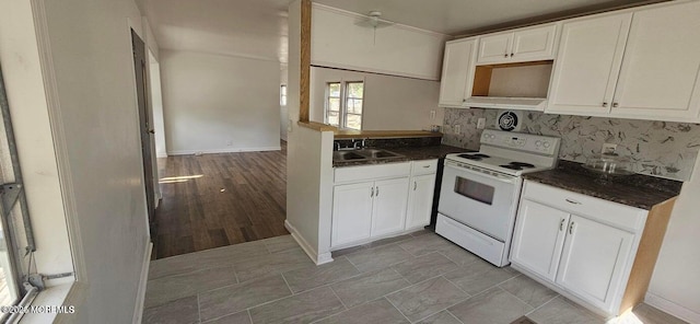 1 Panda Ln, Whiting, NJ 08759 - kitchen featuring white range with electric cooktop, dark countertops, a sink, decorative backsplash, and white cabinets