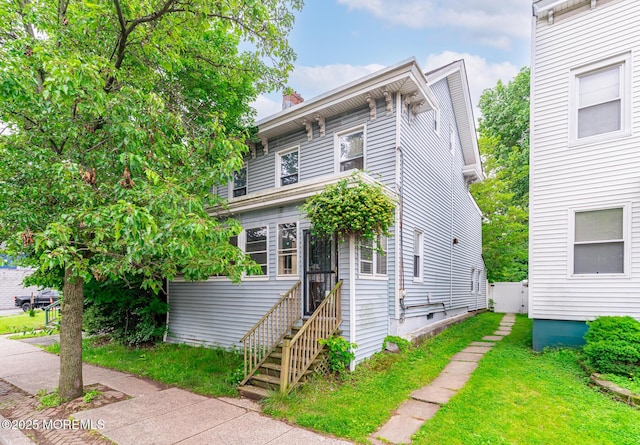 137 Seabreeze Way, Keansburg, NJ 07734 - italianate house with a front yard and a chimney