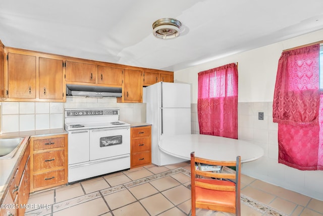137 Seabreeze Way, Keansburg, NJ 07734 - kitchen with white appliances, range hood, light countertops, a sink, and tile walls