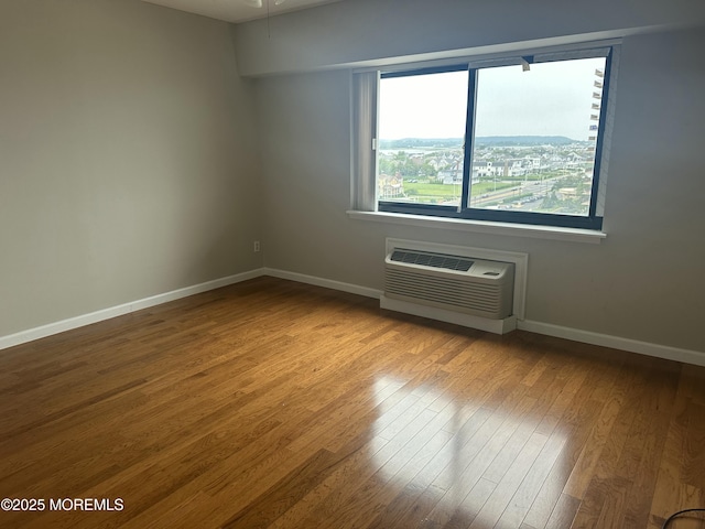 45 Ocean Ave Unit 8D, Monmouth Beach, NJ 07750 - empty room featuring a wall mounted air conditioner, wood finished floors, and baseboards