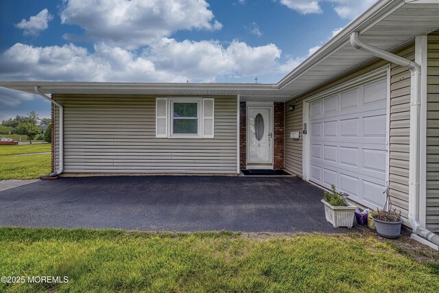 5 Lodge Ct, Brick, NJ 08724 - property entrance with driveway, a garage, and a lawn