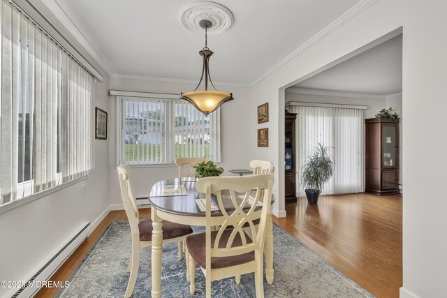5 Lodge Ct, Brick, NJ 08724 - dining area with a baseboard radiator, wood finished floors, healthy amount of natural light, crown molding, and baseboards