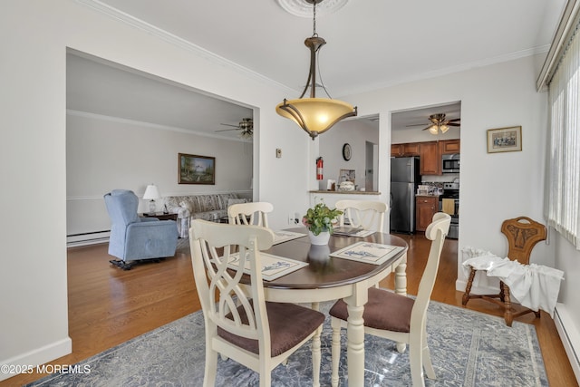 5 Lodge Ct, Brick, NJ 08724 - dining space with a ceiling fan, a baseboard radiator, dark wood-style flooring, crown molding, and baseboard heating