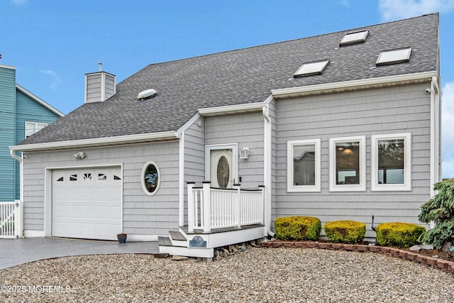 654 Fairview Ln, Forked River, NJ 08731 - view of front facade with concrete driveway, roof with shingles, a garage, and a chimney