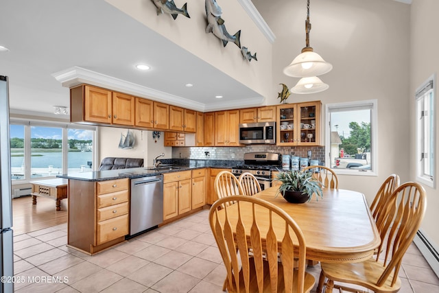 654 Fairview Ln, Forked River, NJ 08731 - kitchen with appliances with stainless steel finishes, baseboard heating, dark countertops, light tile patterned floors, and crown molding