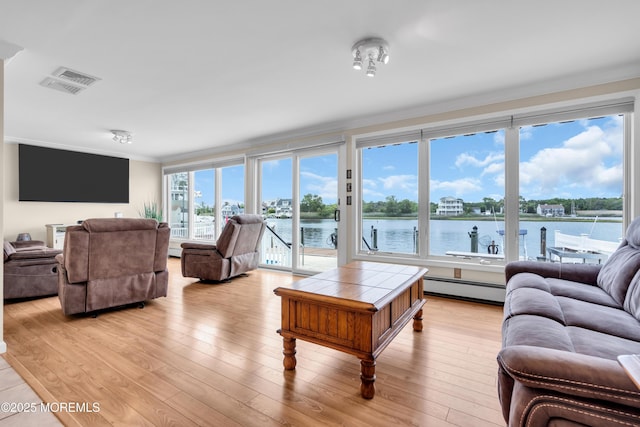 654 Fairview Ln, Forked River, NJ 08731 - living area featuring baseboard heating, ornamental molding, light wood-type flooring, and a water view