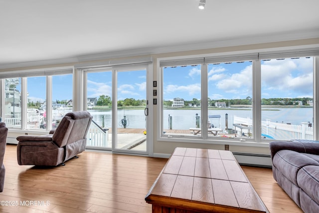 654 Fairview Ln, Forked River, NJ 08731 - living room featuring crown molding, a baseboard heating unit, light wood-type flooring, and a water view