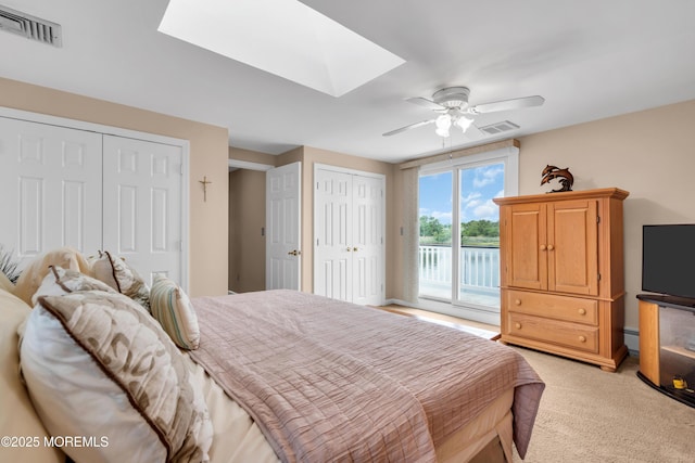654 Fairview Ln, Forked River, NJ 08731 - bedroom featuring access to outside, a skylight, light colored carpet, multiple closets, and a ceiling fan
