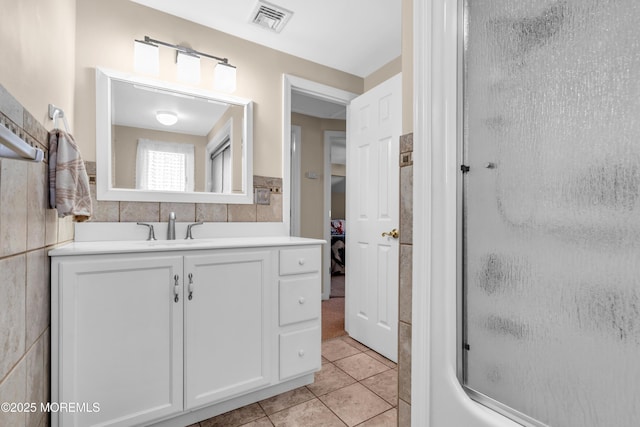 654 Fairview Ln, Forked River, NJ 08731 - full bath with tile walls, tile patterned floors, vanity, a wainscoted wall, and shower / bath combination with glass door