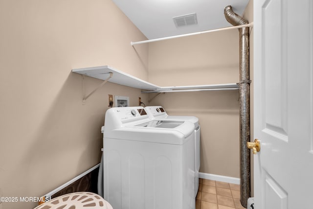 654 Fairview Ln, Forked River, NJ 08731 - laundry area with washing machine and clothes dryer, light tile patterned flooring, and baseboards