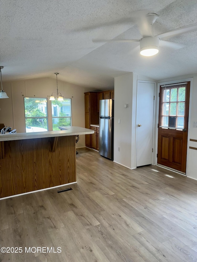 11 B Trail Trail, Brick, NJ 08724 - kitchen featuring freestanding refrigerator, a ceiling fan, brown cabinetry, a textured ceiling, and light countertops