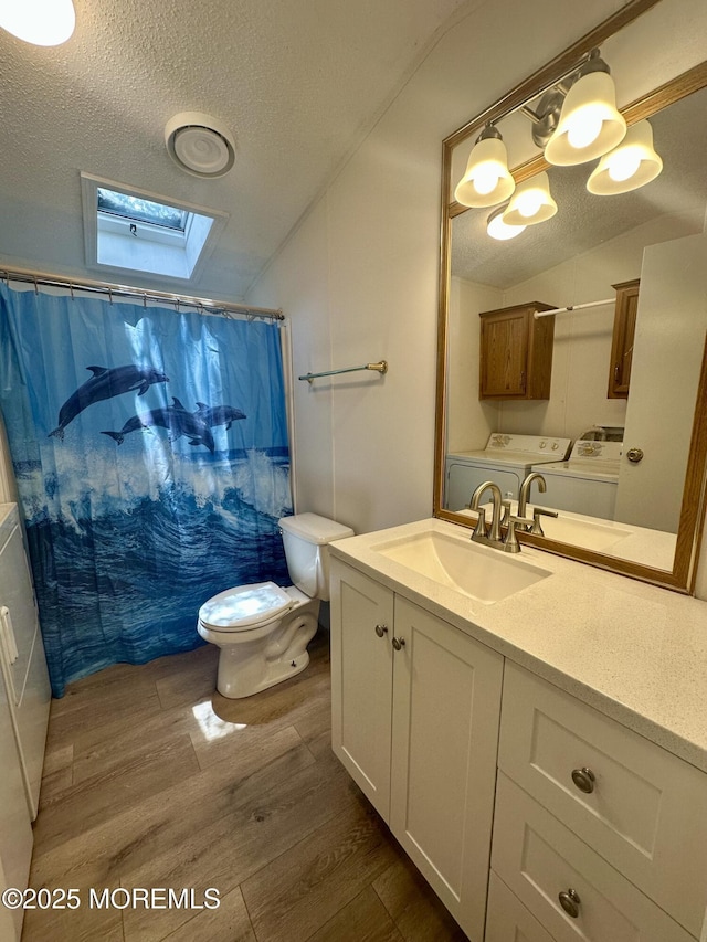 11 B Trail Trail, Brick, NJ 08724 - full bathroom with washing machine and dryer, a textured ceiling, lofted ceiling, wood finished floors, and a skylight