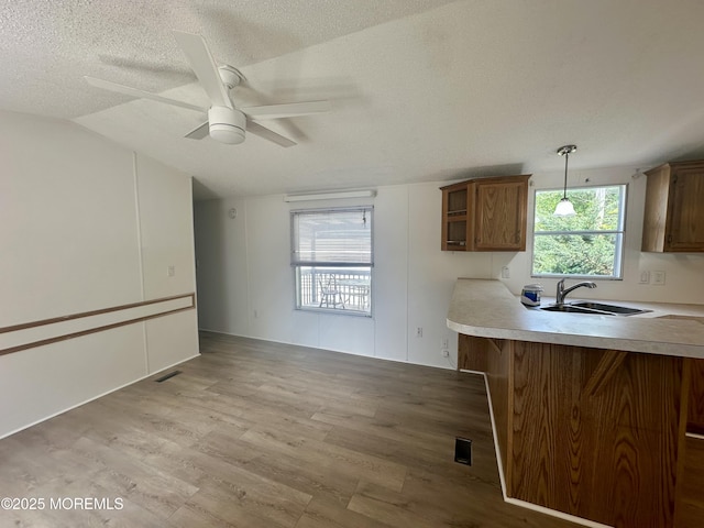 11 B Trail Trail, Brick, NJ 08724 - kitchen featuring light wood-type flooring, a textured ceiling, a ceiling fan, brown cabinets, and light countertops