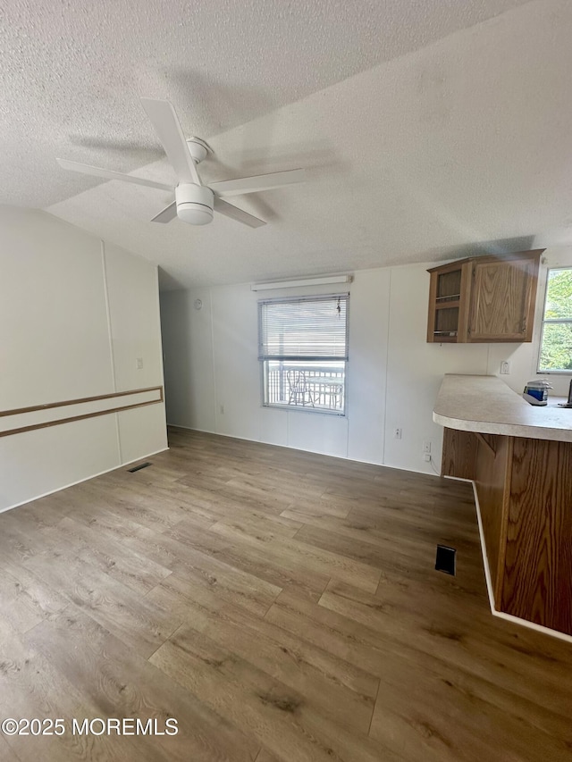 11 B Trail Trail, Brick, NJ 08724 - unfurnished living room featuring a textured ceiling, wood finished floors, lofted ceiling, and a ceiling fan