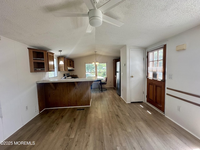 11 B Trail Trail, Brick, NJ 08724 - kitchen with a peninsula, wood finished floors, a textured ceiling, freestanding refrigerator, and open shelves