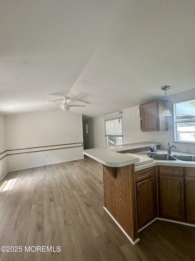 11 B Trail Trail, Brick, NJ 08724 - kitchen featuring a textured ceiling, wood finished floors, light countertops, a ceiling fan, and plenty of natural light