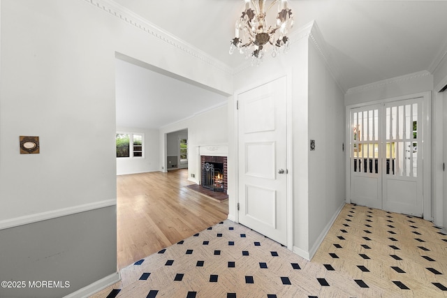 23 Fox Hill Dr, Little Silver, NJ 07739 - entryway with crown molding, baseboards, a chandelier, and a brick fireplace