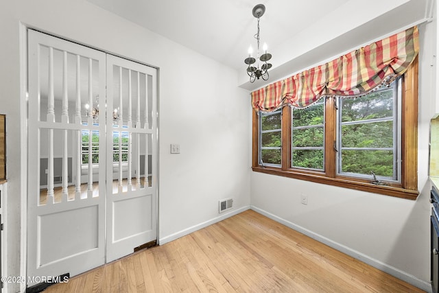 23 Fox Hill Dr, Little Silver, NJ 07739 - unfurnished dining area with a chandelier, light wood-type flooring, baseboards, and plenty of natural light