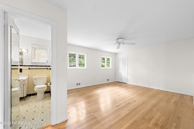23 Fox Hill Dr, Little Silver, NJ 07739 - spare room with ceiling fan, light wood finished floors, and tile walls