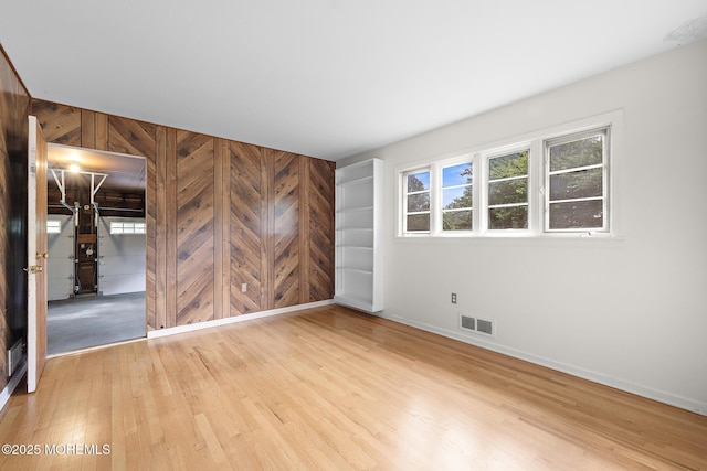 23 Fox Hill Dr, Little Silver, NJ 07739 - empty room featuring wood finished floors, wood walls, and baseboards