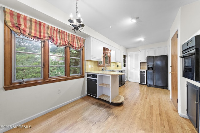 23 Fox Hill Dr, Little Silver, NJ 07739 - kitchen featuring black appliances, light countertops, light wood-type flooring, white cabinets, and a chandelier