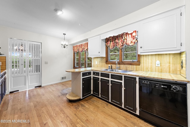 23 Fox Hill Dr, Little Silver, NJ 07739 - kitchen featuring black dishwasher, a sink, a chandelier, backsplash, and light wood-style floors
