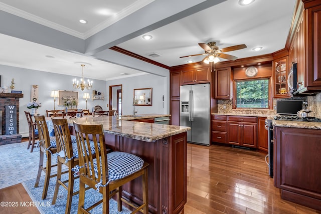 711 Hardean Rd, Brick, NJ 08724 - kitchen featuring stainless steel appliances, a ceiling fan, decorative backsplash, a breakfast bar area, and recessed lighting