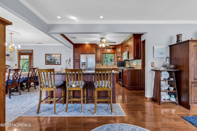 711 Hardean Rd, Brick, NJ 08724 - kitchen with stainless steel appliances, dark wood-style flooring, a breakfast bar, light stone counters, and a chandelier