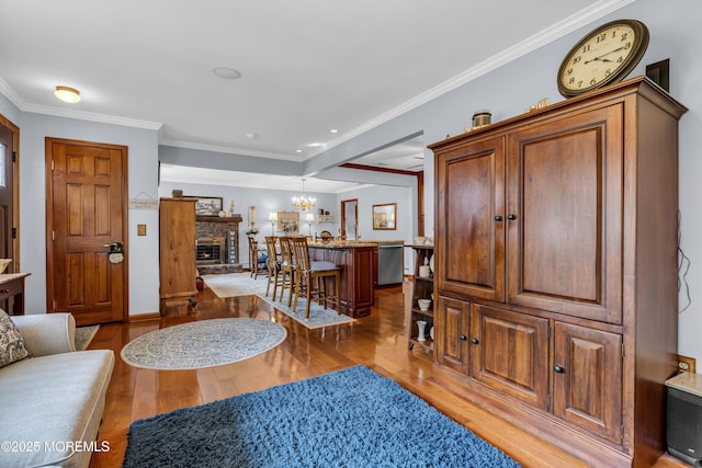 711 Hardean Rd, Brick, NJ 08724 - foyer featuring hardwood / wood-style floors, ornamental molding, a brick fireplace, and a chandelier