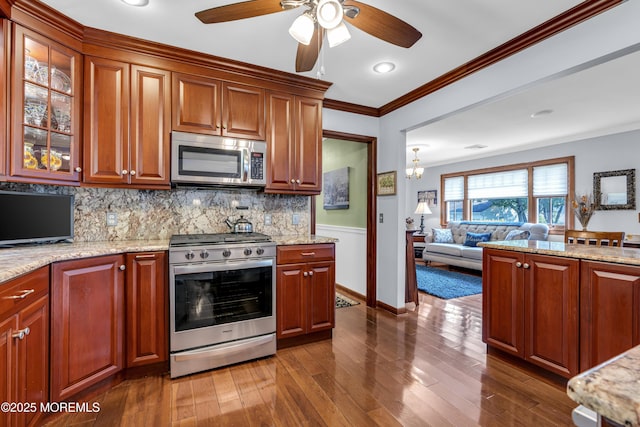 711 Hardean Rd, Brick, NJ 08724 - kitchen with appliances with stainless steel finishes, a ceiling fan, open floor plan, ornamental molding, and tasteful backsplash