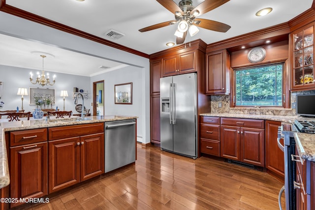 711 Hardean Rd, Brick, NJ 08724 - kitchen with stainless steel appliances, a sink, a chandelier, ceiling fan, and decorative backsplash