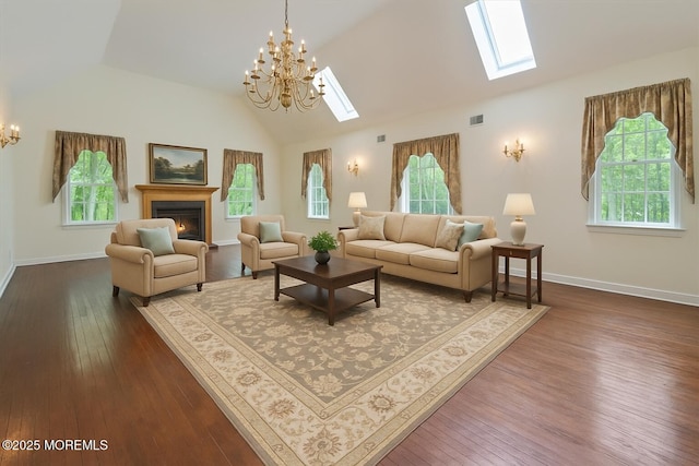 2 Warrenton Ln, Colts Neck, NJ 07722 - living area with a chandelier, a skylight, healthy amount of natural light, a warm lit fireplace, and high vaulted ceiling