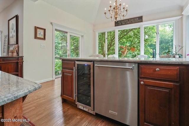 2 Warrenton Ln, Colts Neck, NJ 07722 - kitchen featuring wine cooler, stainless steel dishwasher, healthy amount of natural light, a chandelier, and vaulted ceiling