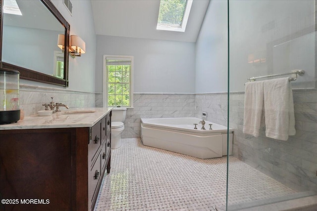 2 Warrenton Ln, Colts Neck, NJ 07722 - bathroom featuring a skylight, lofted ceiling, a bath, vanity, and tile walls