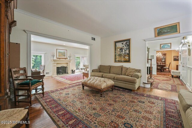 2 Warrenton Ln, Colts Neck, NJ 07722 - living area with ornamental molding, wood finished floors, and a fireplace with raised hearth