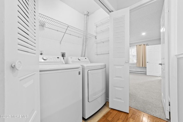 642B Madison Dr Unit 642B, Monroe, NJ 08831 - laundry area with baseboard heating, washing machine and dryer, and light wood-style flooring