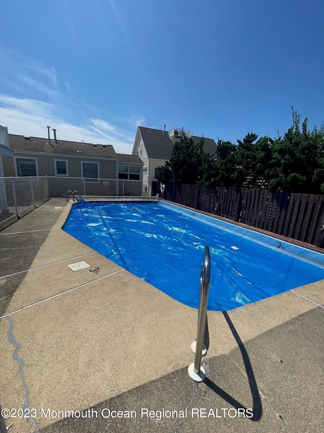 1301 SW Central Ave Unit B8, Seaside Park, NJ 08752 - community pool featuring a fenced backyard and a patio