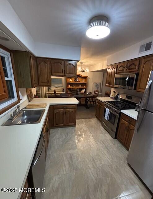 1301 SW Central Ave Unit B8, Seaside Park, NJ 08752 - kitchen with stainless steel appliances, light countertops, dark brown cabinets, and light marble finish flooring