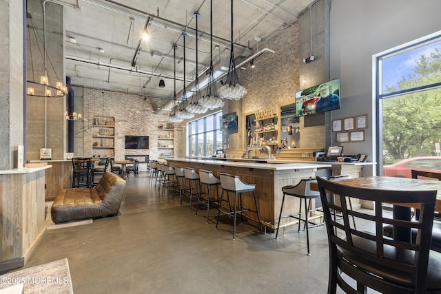 1 Carriage City Plz Unit 711, Rahway, NJ 07065 - kitchen featuring a towering ceiling, finished concrete flooring, plenty of natural light, and a chandelier