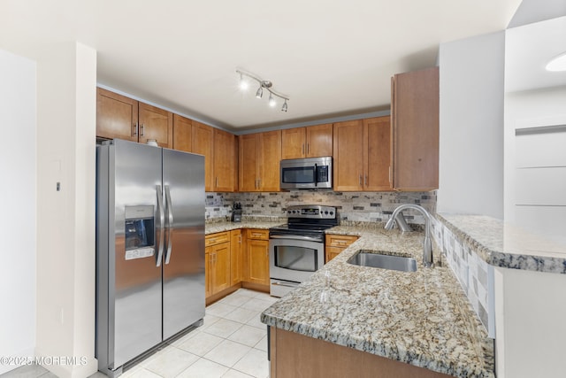 1 Carriage City Plz Unit 711, Rahway, NJ 07065 - kitchen featuring stainless steel appliances, a peninsula, decorative backsplash, light stone countertops, and light tile patterned floors