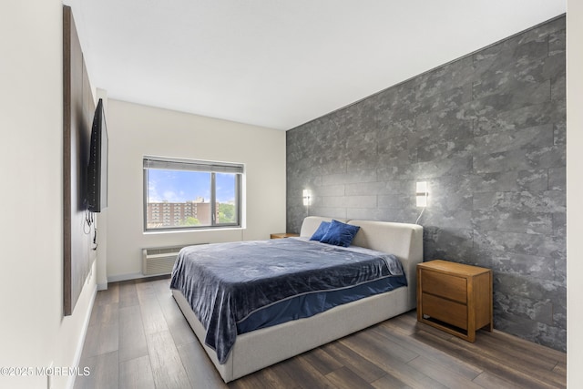1 Carriage City Plz Unit 711, Rahway, NJ 07065 - bedroom with wood finished floors, an accent wall, tile walls, and a wall mounted AC