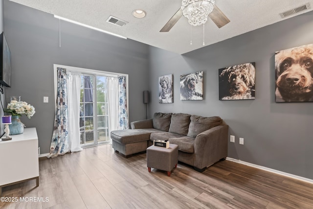 70 Madison Ct, Tinton Falls, NJ 07712 - living room featuring a ceiling fan, wood finished floors, and a textured ceiling