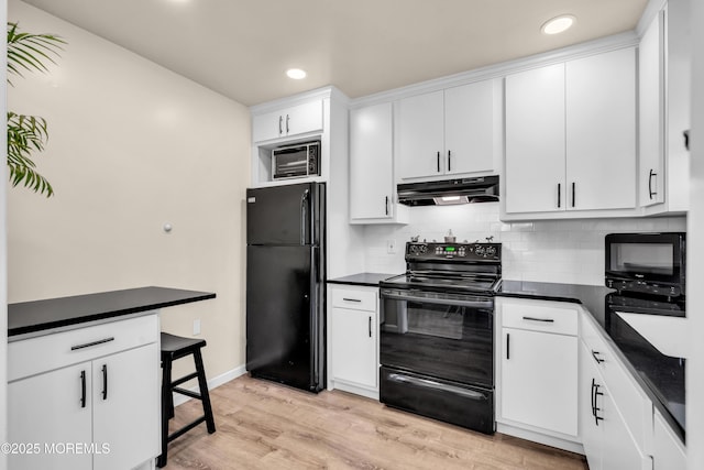 29 Bowie Dr, Whiting, NJ 08759 - kitchen featuring black appliances, range hood, dark countertops, decorative backsplash, and light wood-style flooring