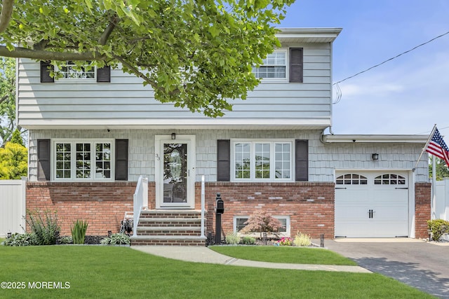 33 Fleetwood Dr, Hazlet, NJ 07730 - view of front of house featuring brick siding, a garage, and a front yard