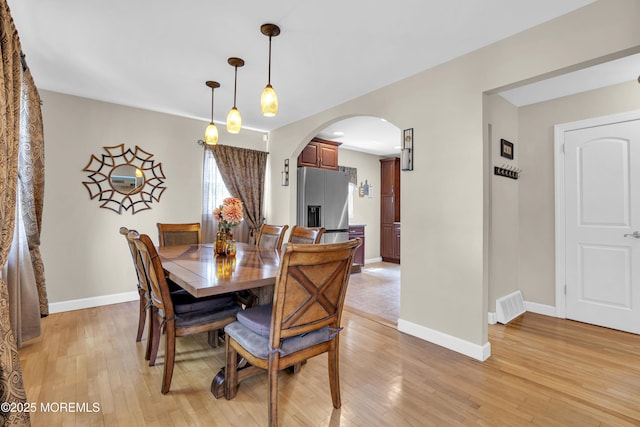 33 Fleetwood Dr, Hazlet, NJ 07730 - dining area with arched walkways, light wood-style flooring, and baseboards