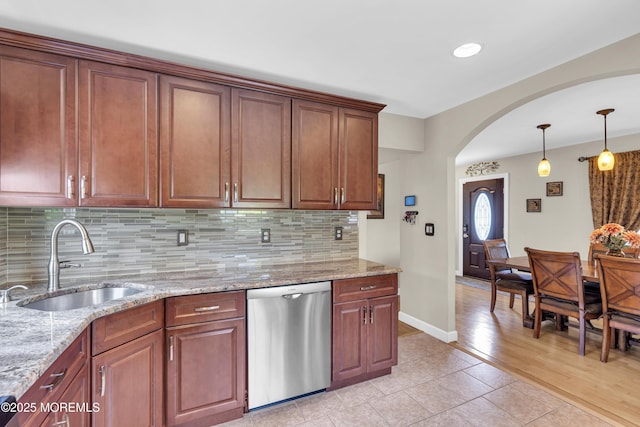 33 Fleetwood Dr, Hazlet, NJ 07730 - kitchen with dishwasher, a sink, arched walkways, backsplash, and baseboards