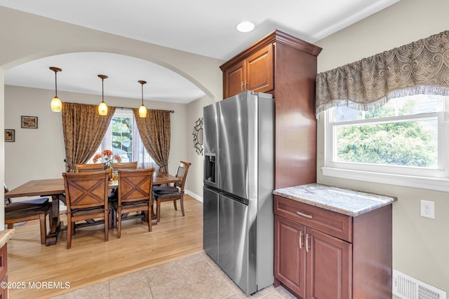 33 Fleetwood Dr, Hazlet, NJ 07730 - kitchen featuring stainless steel fridge with ice dispenser, arched walkways, light stone countertops, pendant lighting, and recessed lighting