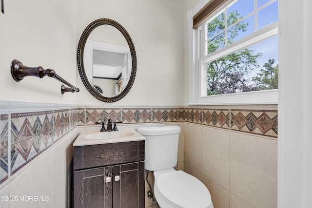 33 Fleetwood Dr, Hazlet, NJ 07730 - half bath with tile walls, vanity, toilet, and wainscoting